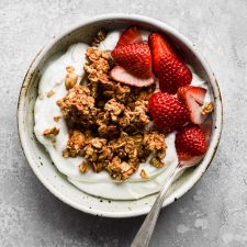Peanut butter granola in a bowl with yogurt and strawberries
