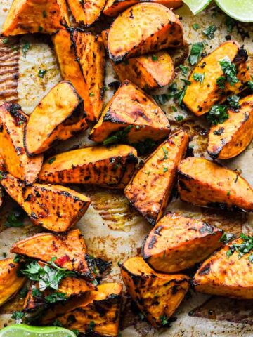Close up shot of roasted sweet potatoes with cilantro on top.