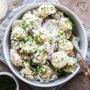 Sour cream and onion potato salad in a bowl for serving.