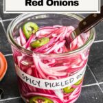 Spicy pickled red onions in a jar.
