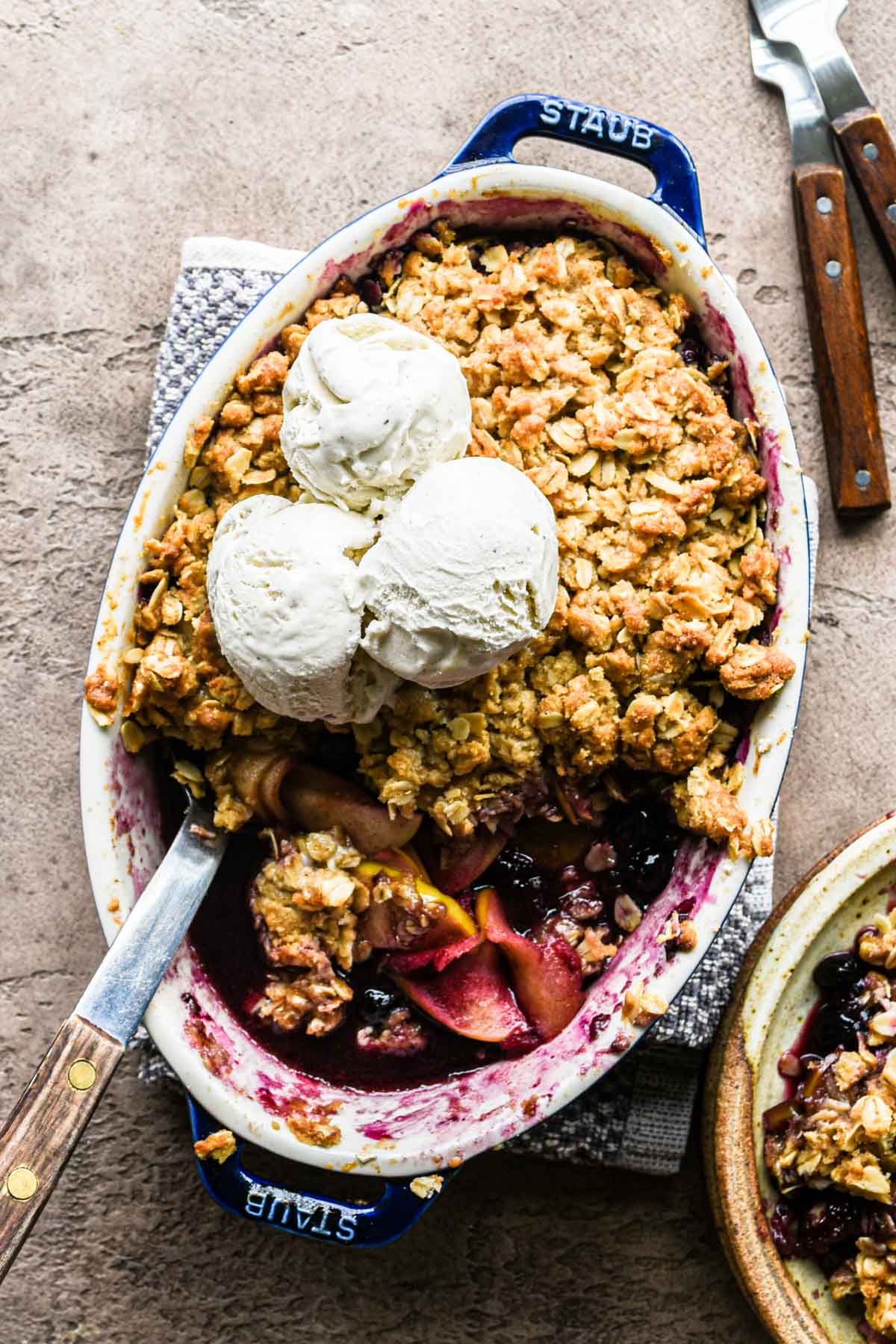 Freshly baked apple blueberry crumble with ice cream.