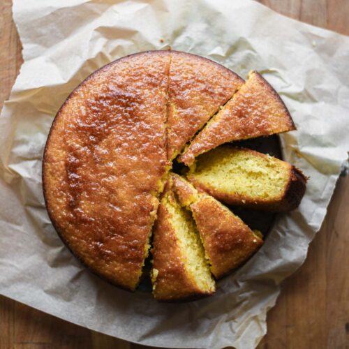 lemon honey cake with slices cut out.