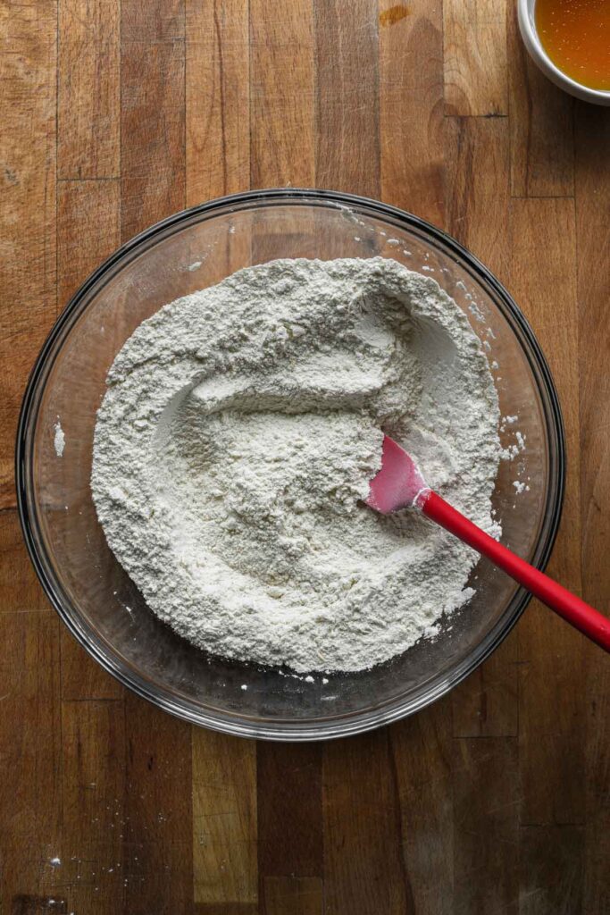 Adding dry ingredients into lemon sugar.