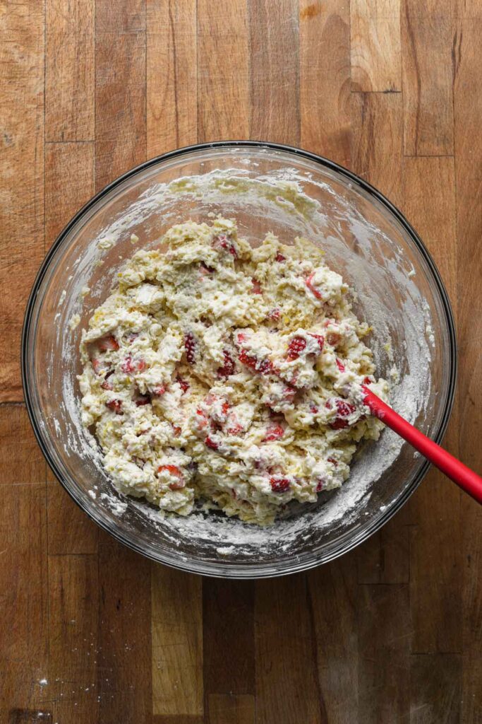Folded in strawberries and completely mixed dough.