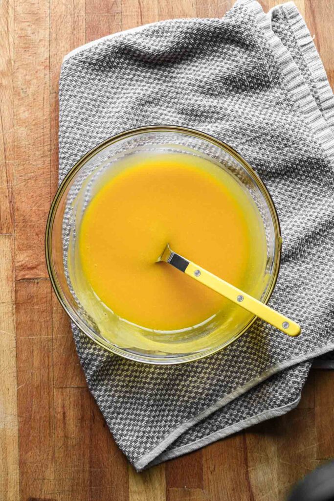Strained curd in a glass bowl.