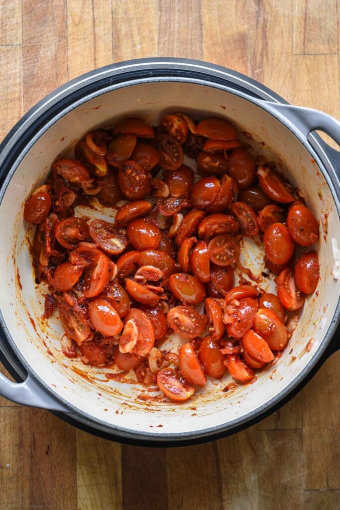 Adding in fresh chopped tomatoes.