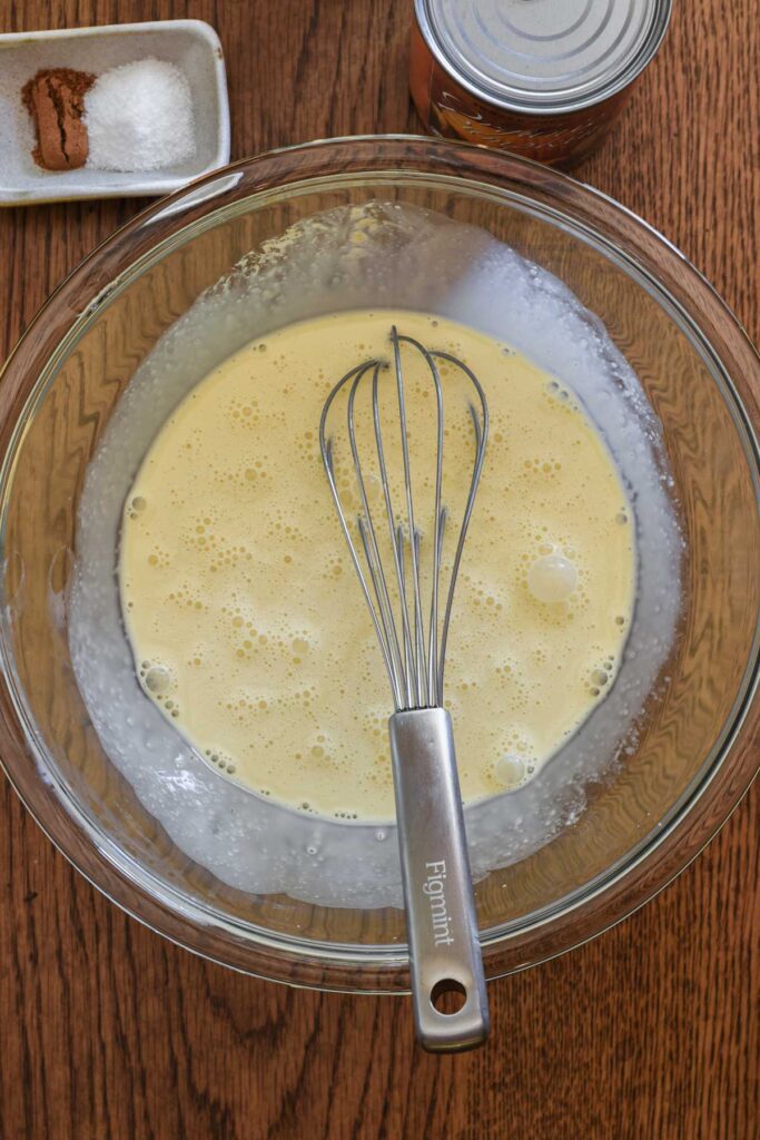 Mixing together of half the wet ingredients in a bowl.